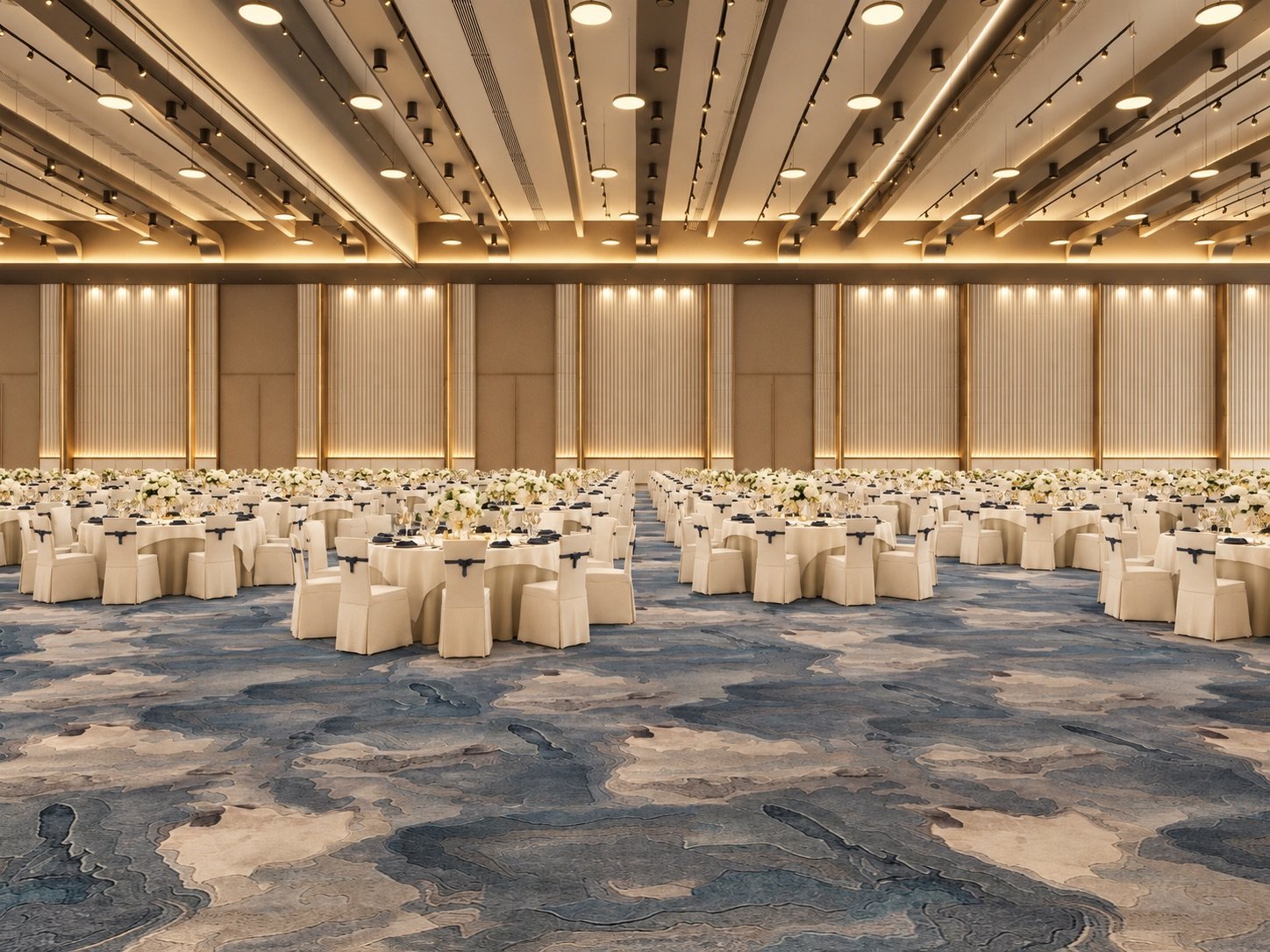 The long wall of a grand hall seen straight on: lit fluted panels and doors behind rows of round tables, an aisle down the middle