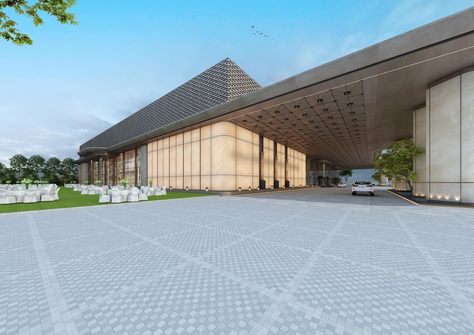 The long glazed flank and folded roof of the Vensa building, seen across the paved forecourt