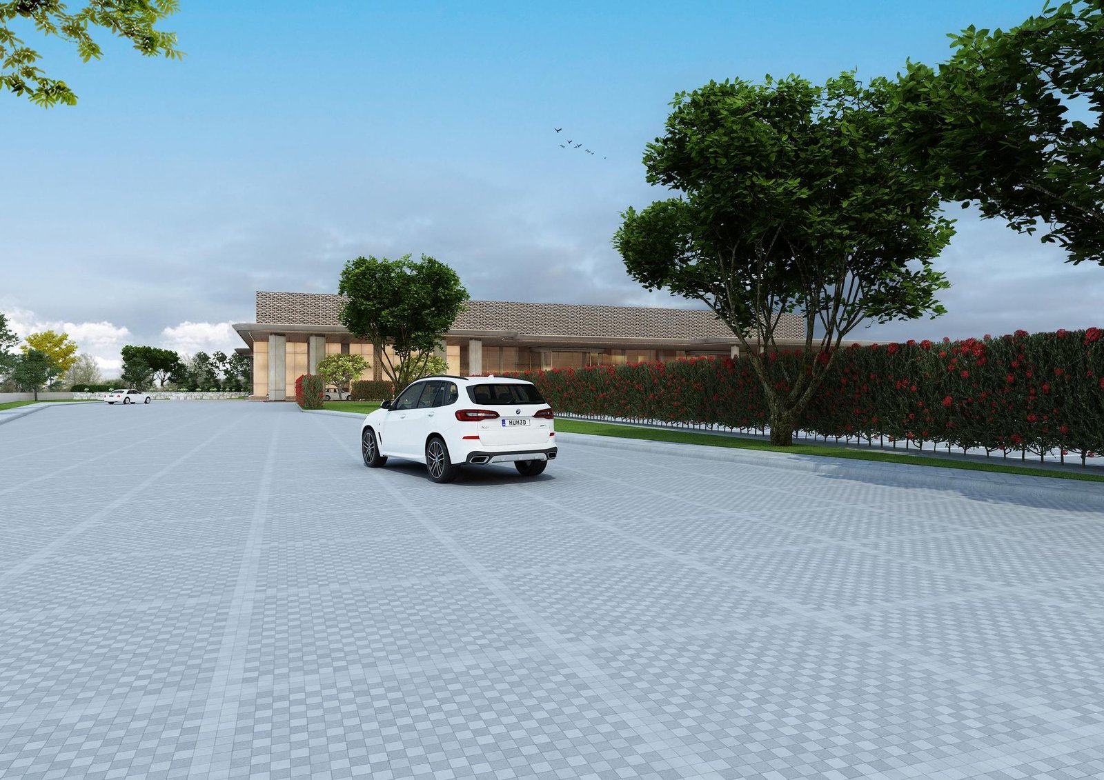 The drive into Vensa, a car approaching the building past trees and hedges