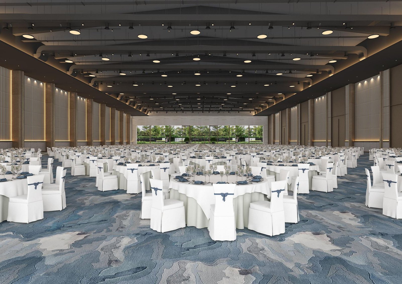 A grand hall seen down its length, set with round tables under rows of downlights, the lawn bright through the glass at the far end