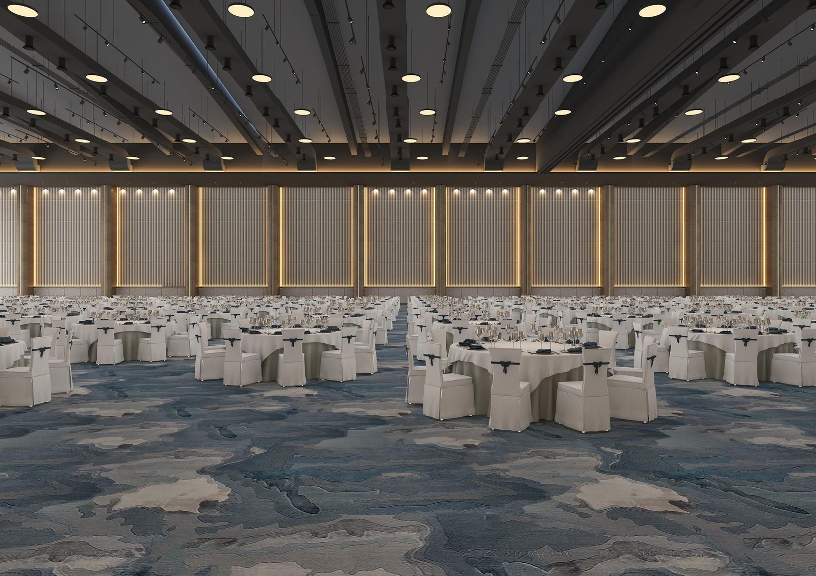 The long wall of Sapphire Hall, seen straight on: fluted panels with brass reveals, round tables of ten across the blue-grey carpet